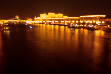 Fototapeta na wymiar Bokeh river in the city at night as a background