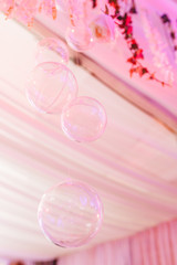 Restaurant room decorated with transparent bubbles hanging from ceiling for weding event