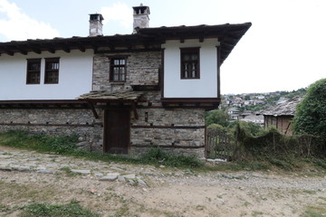 Fototapeta na wymiar Old houses in the historical cultural reserve village of Dolen, Bulgaria. Dolen is famous with its 350 old houses – an example of 19th century Rhodopean architecture. 