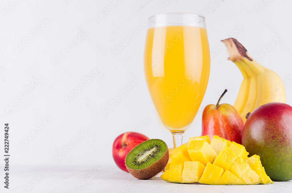 Wall mural healthy food and beverage - summer fresh cocktail of different tropical fruits with sliced ingredien