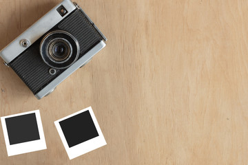 Vintage camera top view on wooden background. Copy space. Mockup for design.