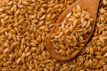 Seeds of golden flax on a white background