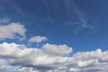 Fluffy white clouds in blue sky with copy space
