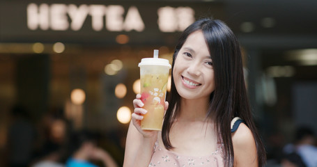  Woman drinking of cheese green tea at Heytea store in the city