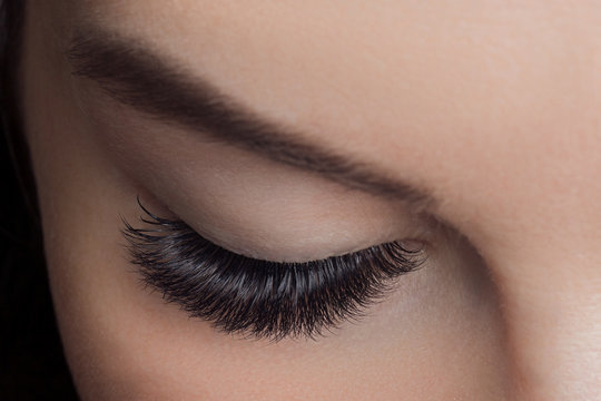 Woman With Long Lashes In Beauty Salon. Concept Eyelash Extension Procedure.