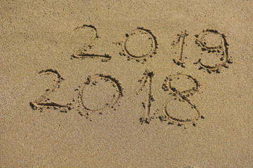 New Year 2019 concept. The inscription on the sand a number message Year 2018 replace 2019