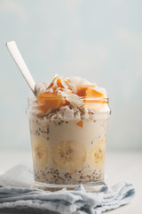 Overnight oatmeal with mango, coconut, banana and chia seeds.