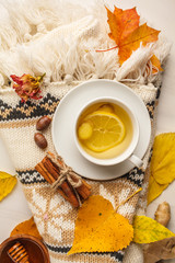 Autumn flt lay of tea with ginger and lemon on a white background.