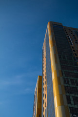 Fototapeta premium yellow and blue skyscrapper facade background