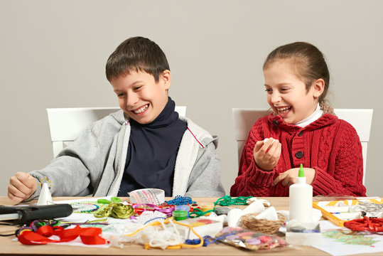 Childrens making decorations for new year holiday. Painting watercolors. Top view. Artwork workplace with creative accessories.