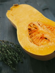 Close up of ripe pumpkin halved lying upon old wooden table. Selective focus on the center. Copy space for your text.