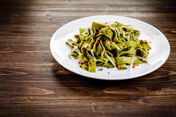 Pasta with cheese on wooden table