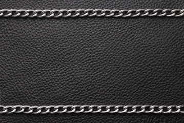 Metal silver chains on luxury black leather texture. - obrazy, fototapety, plakaty