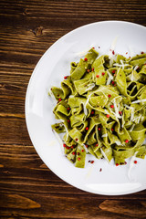 Pasta with cheese on wooden table