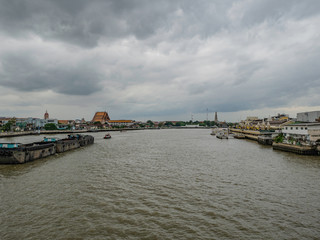 Fototapeta premium Bangkok cityscape view with Chao Phraya River and Rainy cloud sky.