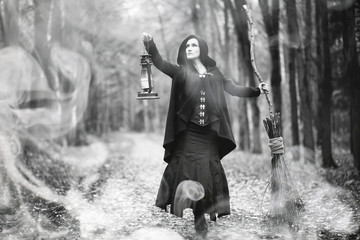 Woman in a witch suit in a dense forest