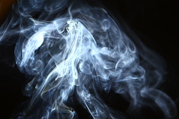 wonderful swirl glowing blue smoke on black background.