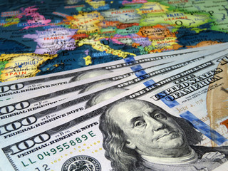 US dollars on the Europe map background. Concept for trade between the United States and Europe, american investment and domination in EU, exchange rate