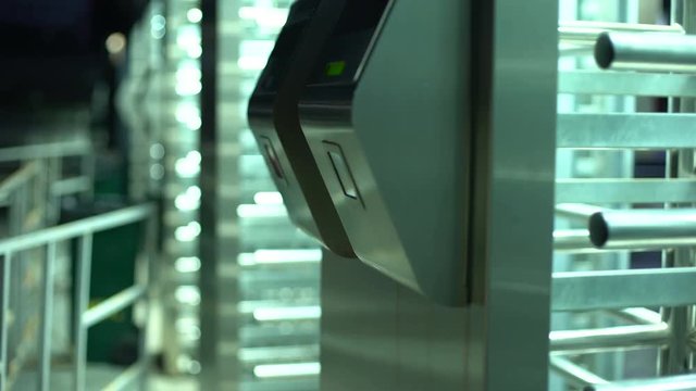 Woman passing electronic turnstile, access control for business center, closeup