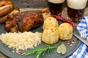 Grilled pork knuckle. Pork knuckle with beer, dumpling and sauerkraut. Oktoberfest. Grillhaxe 