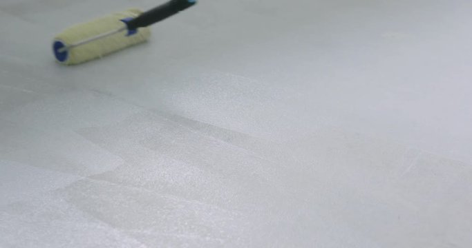Slow motion applying primer on the floor