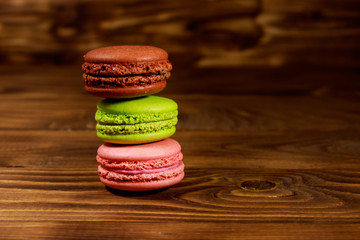 Tasty colorful macaroons on wooden table