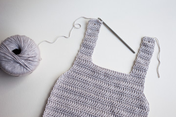 Handmade crochet baby onesie, crocheting with steel crochet hook, using grey cotton yarn