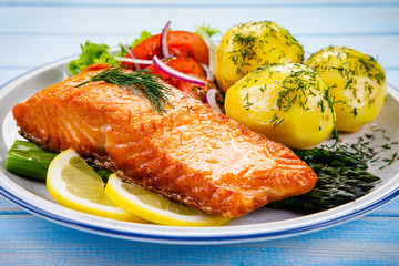 Grilled salmon with boiled potatoes, asparagus and vegetable salad