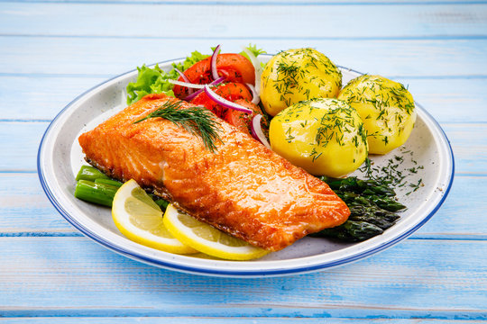 Grilled salmon with boiled potatoes, asparagus and vegetable salad