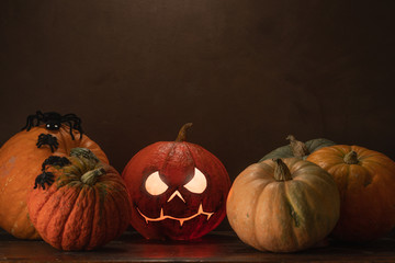 Spooky Halloween pumpkins on wooden planks with vintage background.