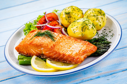 Grilled salmon with boiled potatoes, asparagus and vegetable salad