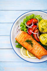 Grilled salmon with boiled potatoes, asparagus and vegetable salad