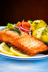 Grilled salmon with boiled potatoes, asparagus and vegetable salad