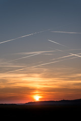 planes crossing the sky at sunrise over Stuttgart