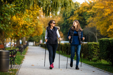 Nordic walking - active people working out in park