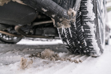 Car tire on snow road. Winter season