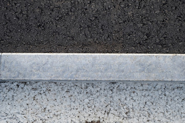 Fototapeta premium New asphalt road, curbs and of gravel and concrete.