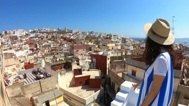 Woman looks at the famous tanger medina from a wonderful terrace