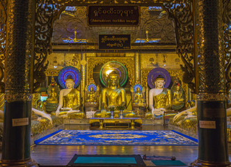 Golden shwedagon buddhas in a prayer room