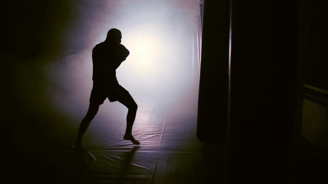 silhouette of a boxer striking in smoke