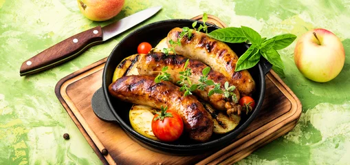Fotobehang Sausages fried with spices and apple © nikolaydonetsk