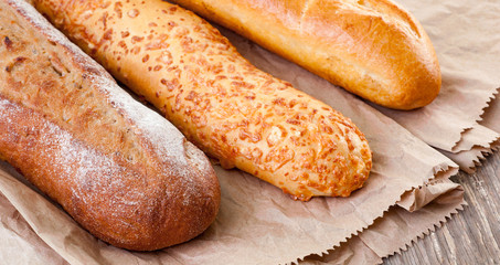 Bread and Bakery Products Isolated on White. Different types of bread: sesame bun, baguette, baked rolls, rustic bread.