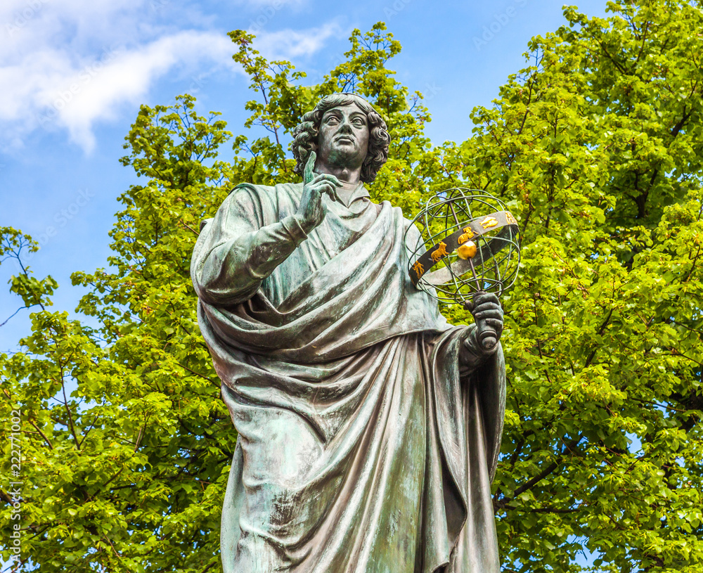 Wall mural famous statue of astronomer nicolaus copernicus (mikolaj kopernik) in torun. poland