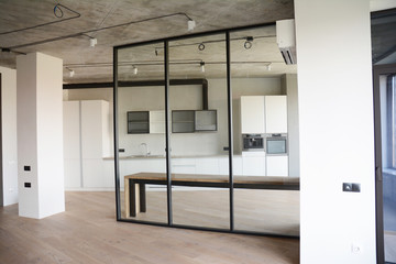 Modern room after remodeling and renovating with contemporery glass wall and loft kitchen interior...