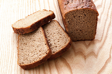 Fototapeta na wymiar loaf of bread on wooden table. top view