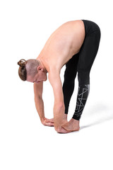 Naklejka premium Strong male practicing yoga,wearing black sportswear. Isolated on white background
