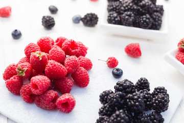 Blueberries, raspberries and blackberries on white background