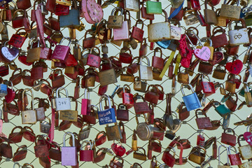 Front view closeup of a fence with love padlocks on the bridge in Salzburg.