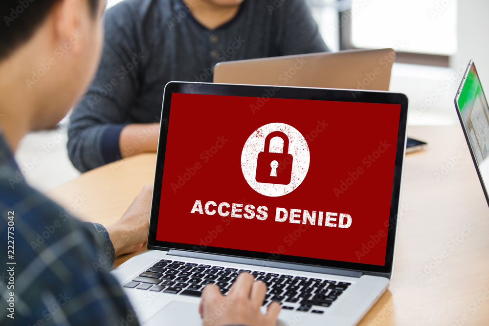 Poster protection security system concept. man working on laptop with access denied text on screen.