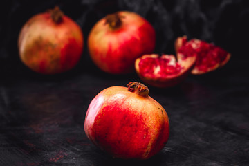 Fototapeta na wymiar Sliced and Raw Fresh Red Pomegranates